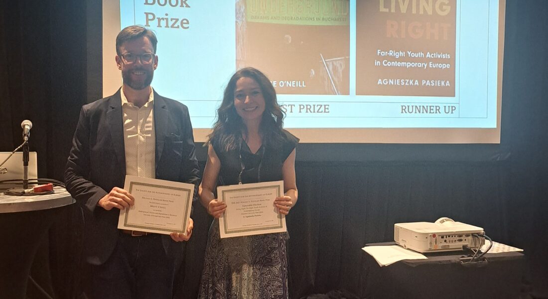 Bruce O'Neill, winner of the 2025 SAE William A. Douglass Prize, and Agnieszka Pasieka, who was awarded Honorable Mention, stand with their awards at the 2025 AAA Annual Meeting in New Orleans.